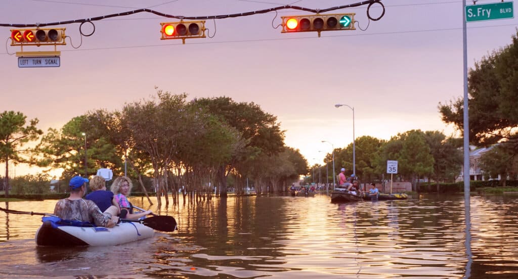 People using boats during a flood evacuation.