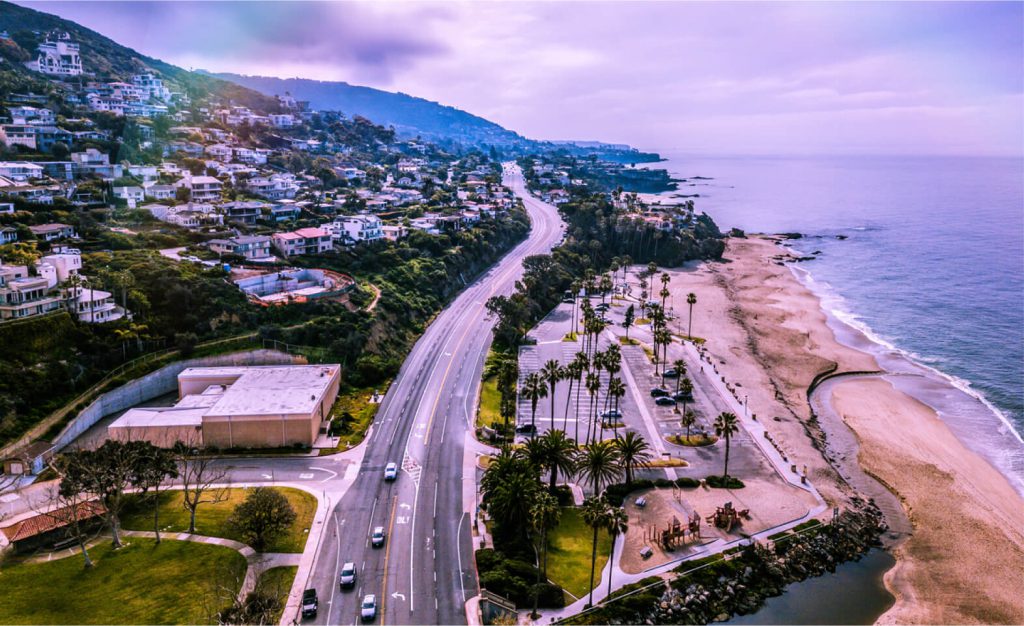 Aerial view of a highway and beach in Laguna Beach, CA.