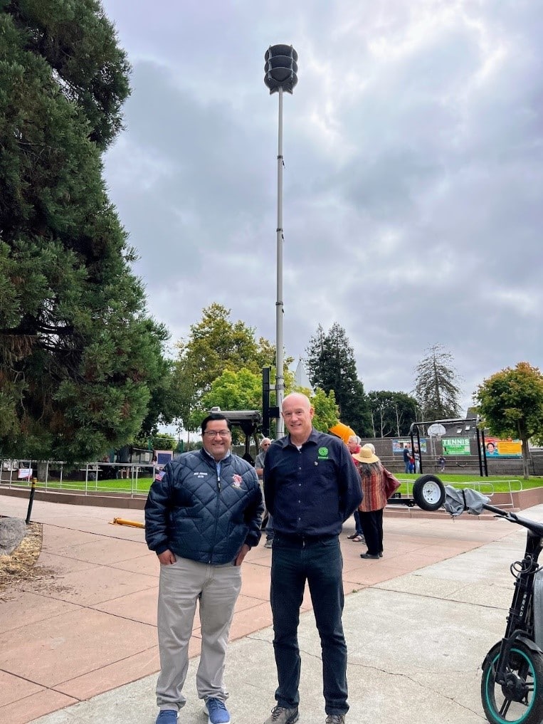 Berkeley Mayor Jesse Arreguin and Genasys SVP Charlie Crocker standing next to one of the new Genasys ACOUSTICS outdoor warning systems at the Berkeley Fire Ready Fest.